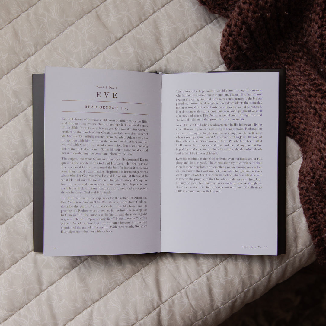 Open book on a textured surface with text visible