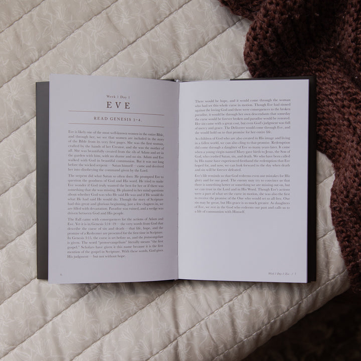 Open book on a textured surface with text visible