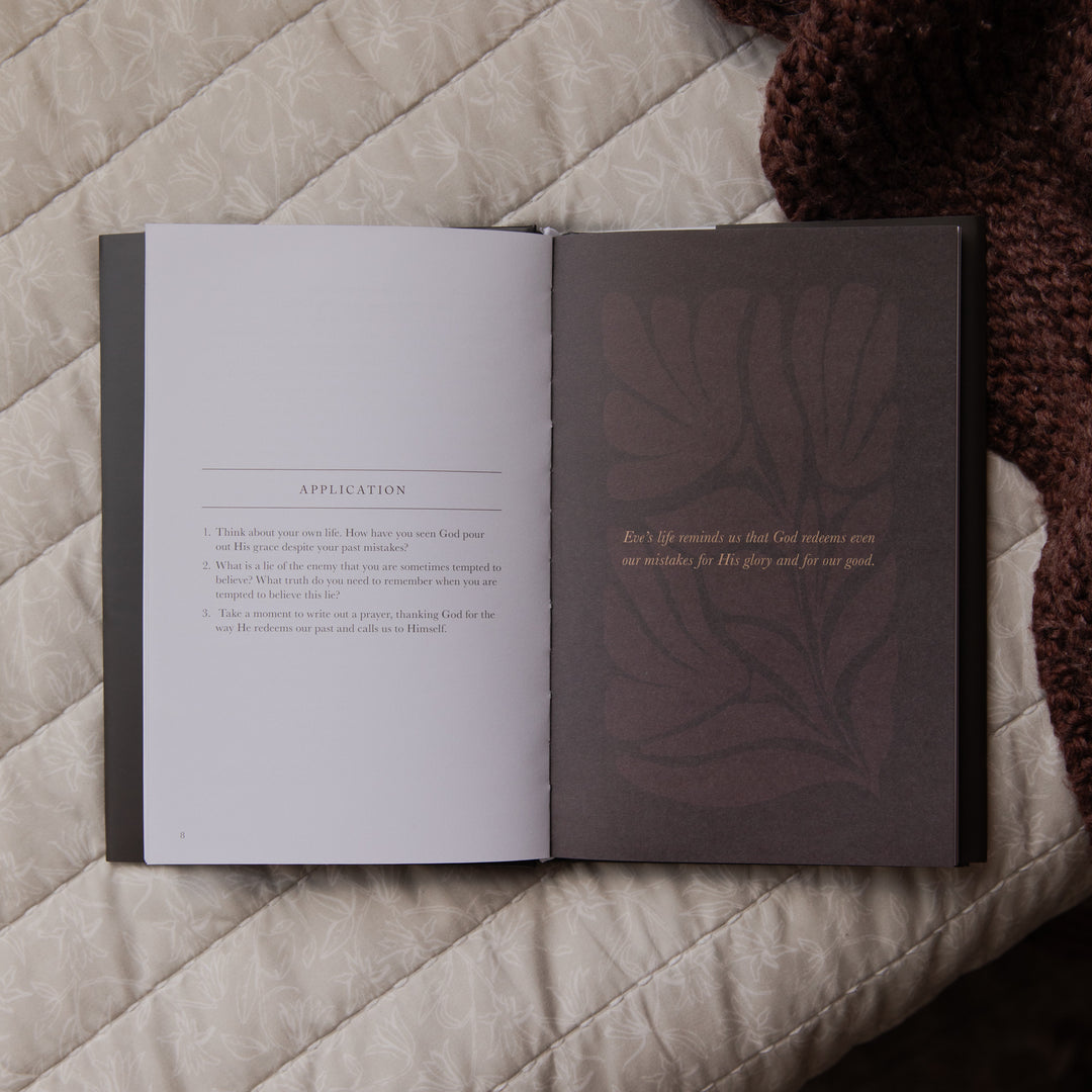 Open book with text and a decorative leaf design on a textured surface