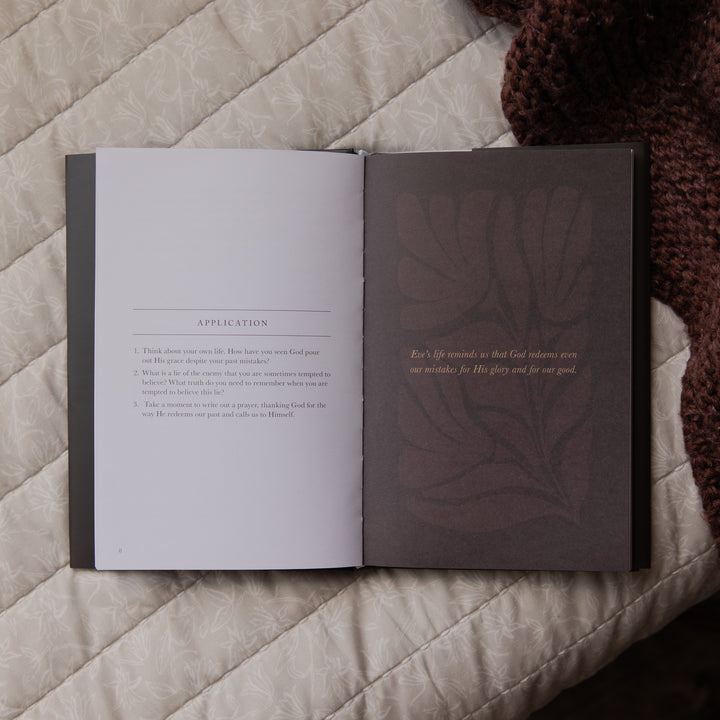 Open book with text and a decorative leaf design on a textured surface