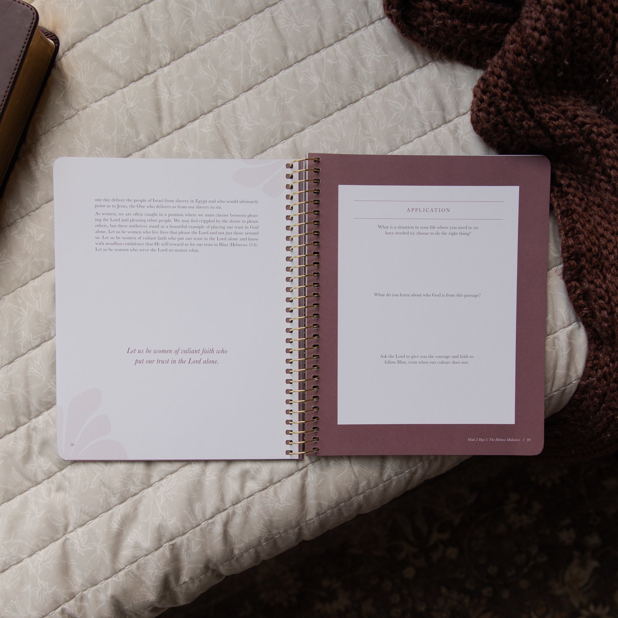 Open spiral-bound bible study on a textured surface with a brown cover