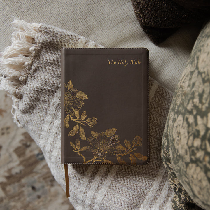 The Holy Bible cover on a blanket on a couch