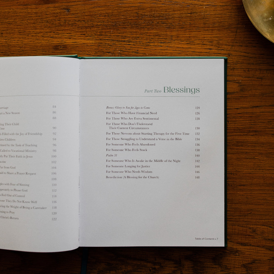 Draw Near to God Book laying on a brown wooden table, opened to the Table of Contents page