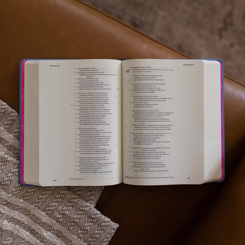 ESV Garden Bible opened to Psalm 44-45 on a leather couch