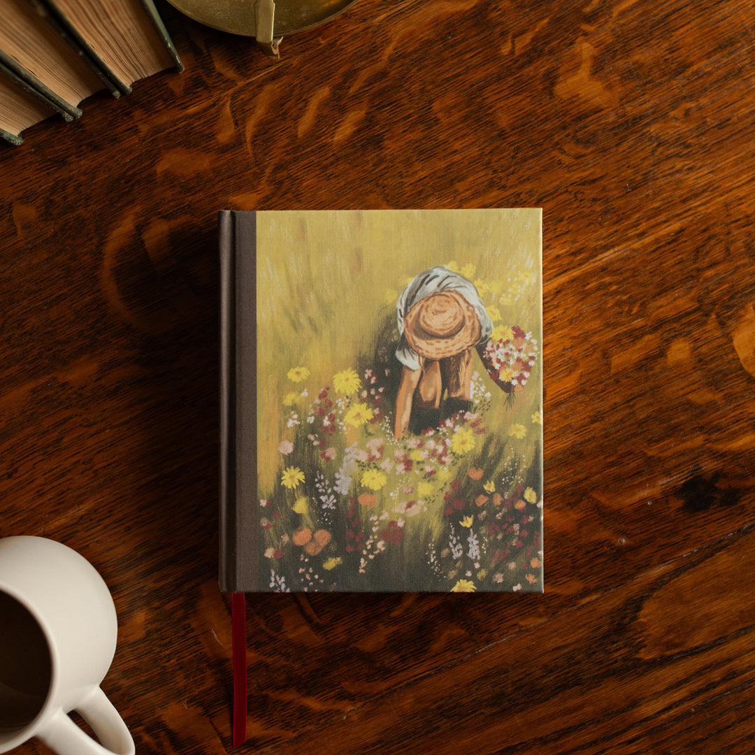 ESV journaling Fields Bible cover on a wooden table next to a white coffee cup