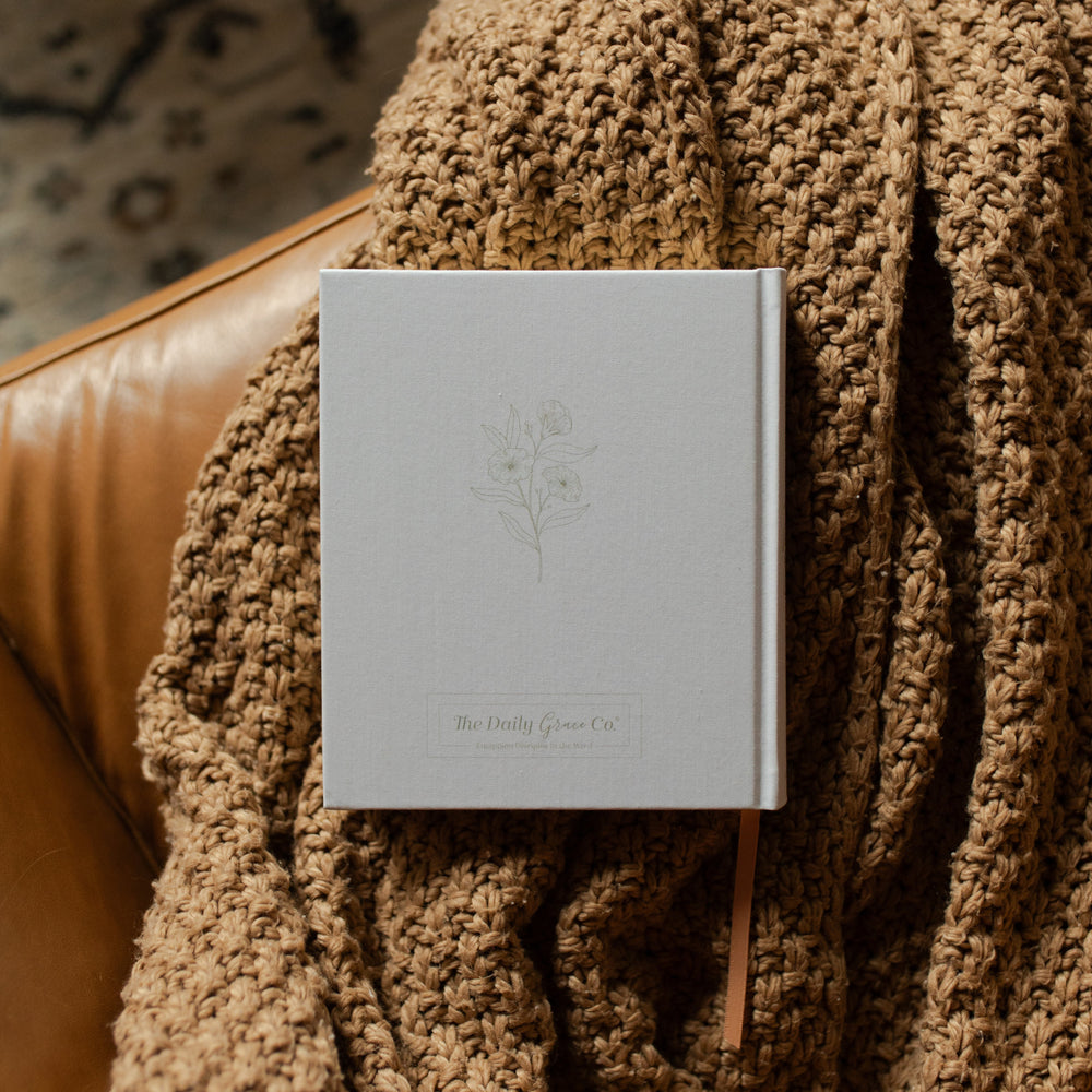 ESV Journaling New Mercies Bible back cover on a brown woven blanket and a leather couch