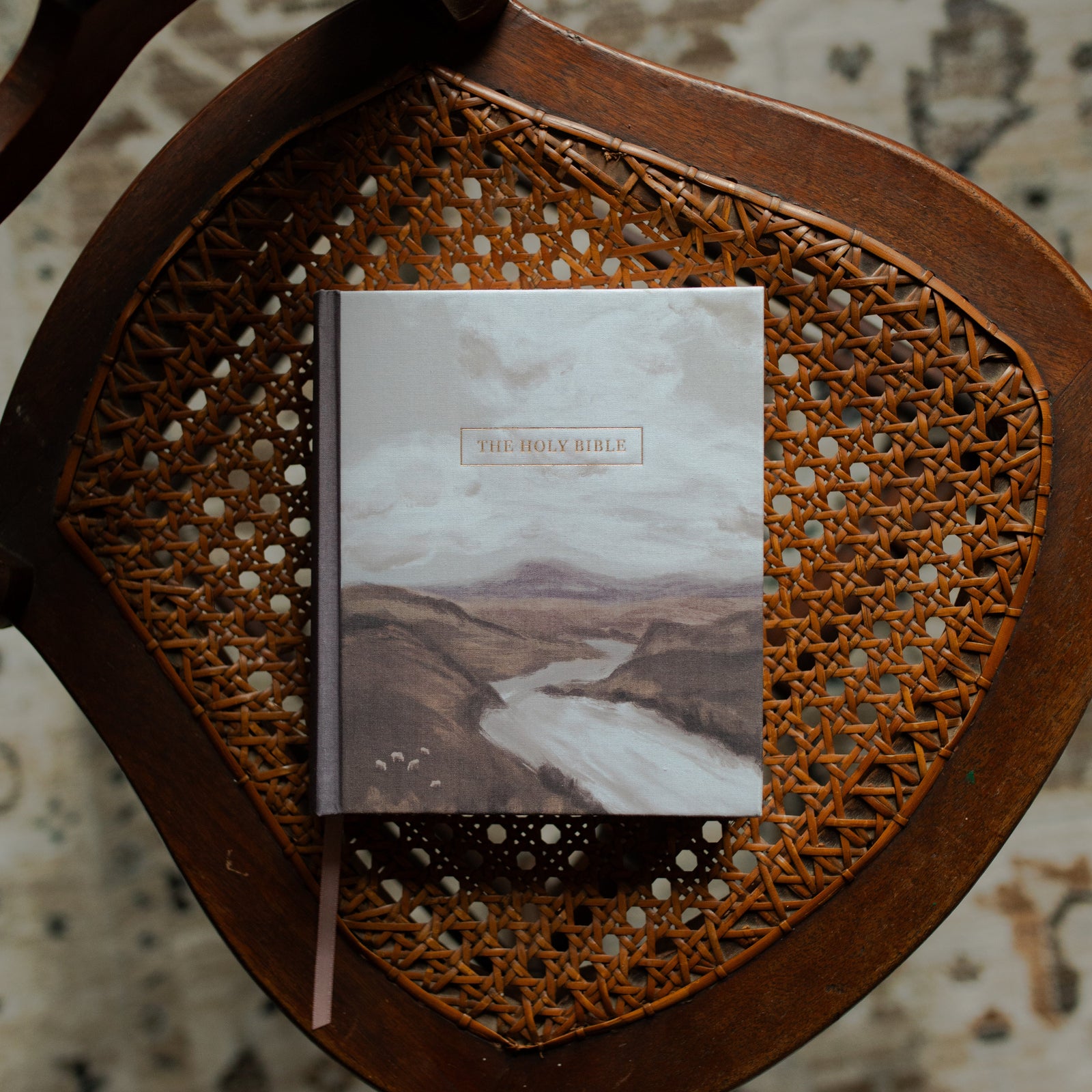ESV Journaling Still Waters Bible cover on a oven chair over a rug