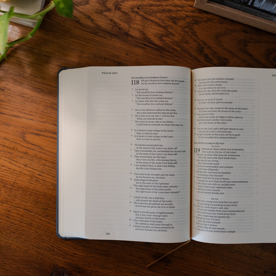 ESV Christian Bible open to psalm 118 on a wood table