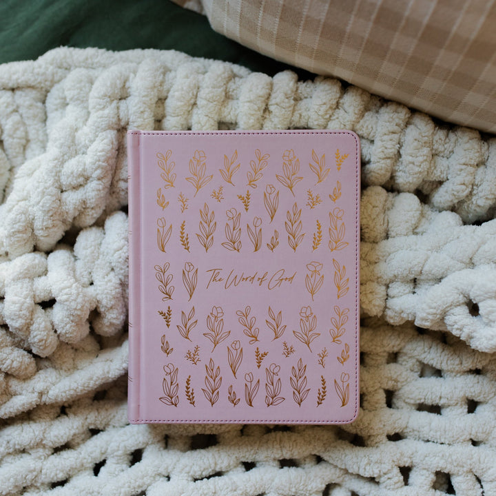 Lilac colored bible with gold colored flowers