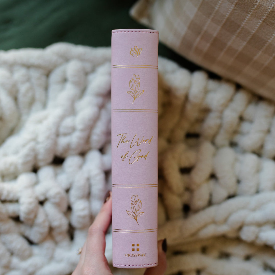 Lilac colored bible with gold designs on book spine