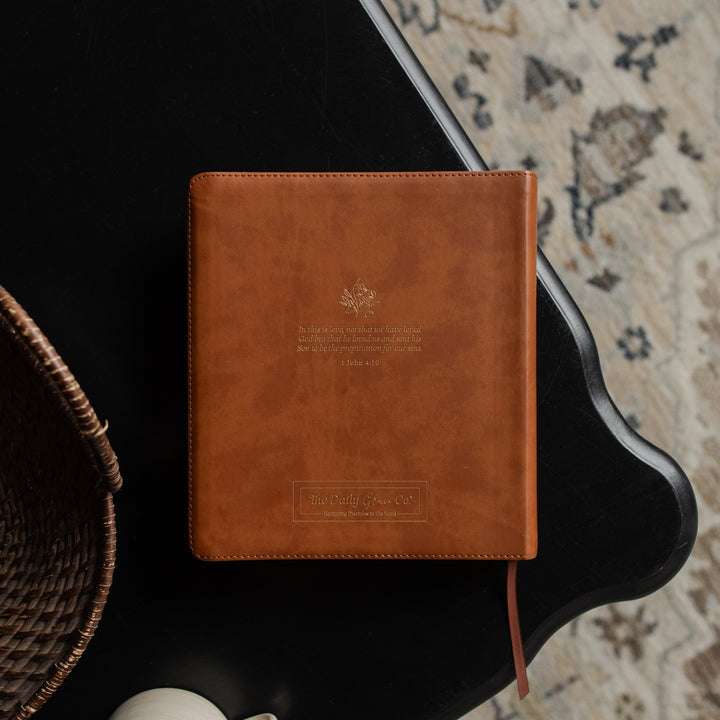 The back of a leather ESV bible cover on a dark wooden table