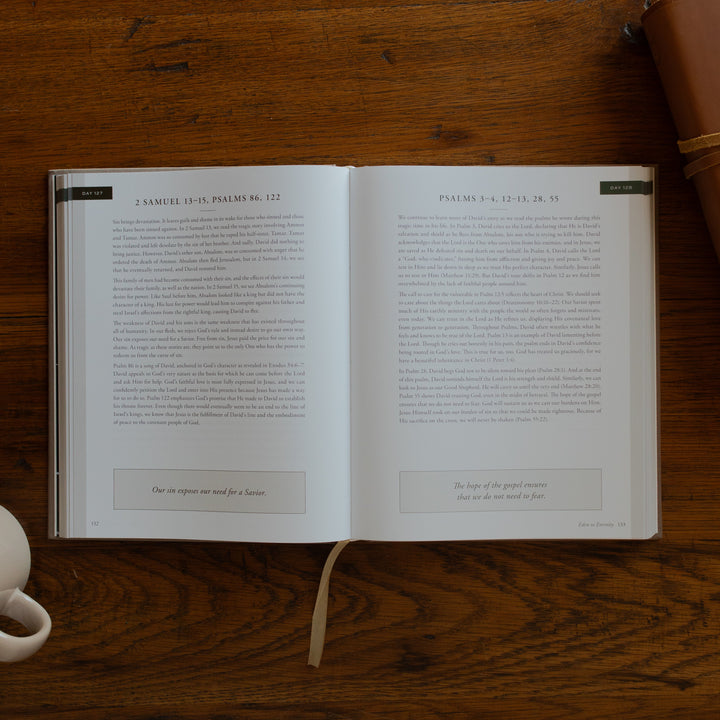 Eden to Eternity Devo opened to day 127 page next to a coffee cup and a leather bible on a wooden table