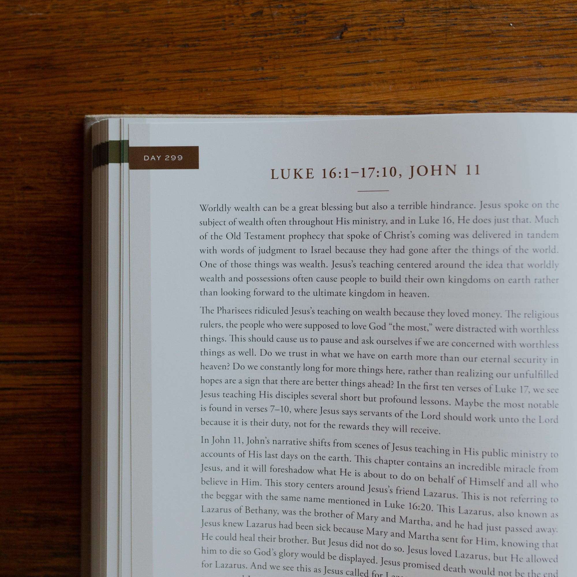 Up close of the Eden to Eternity Devo opened to day 299 page on a wooden table