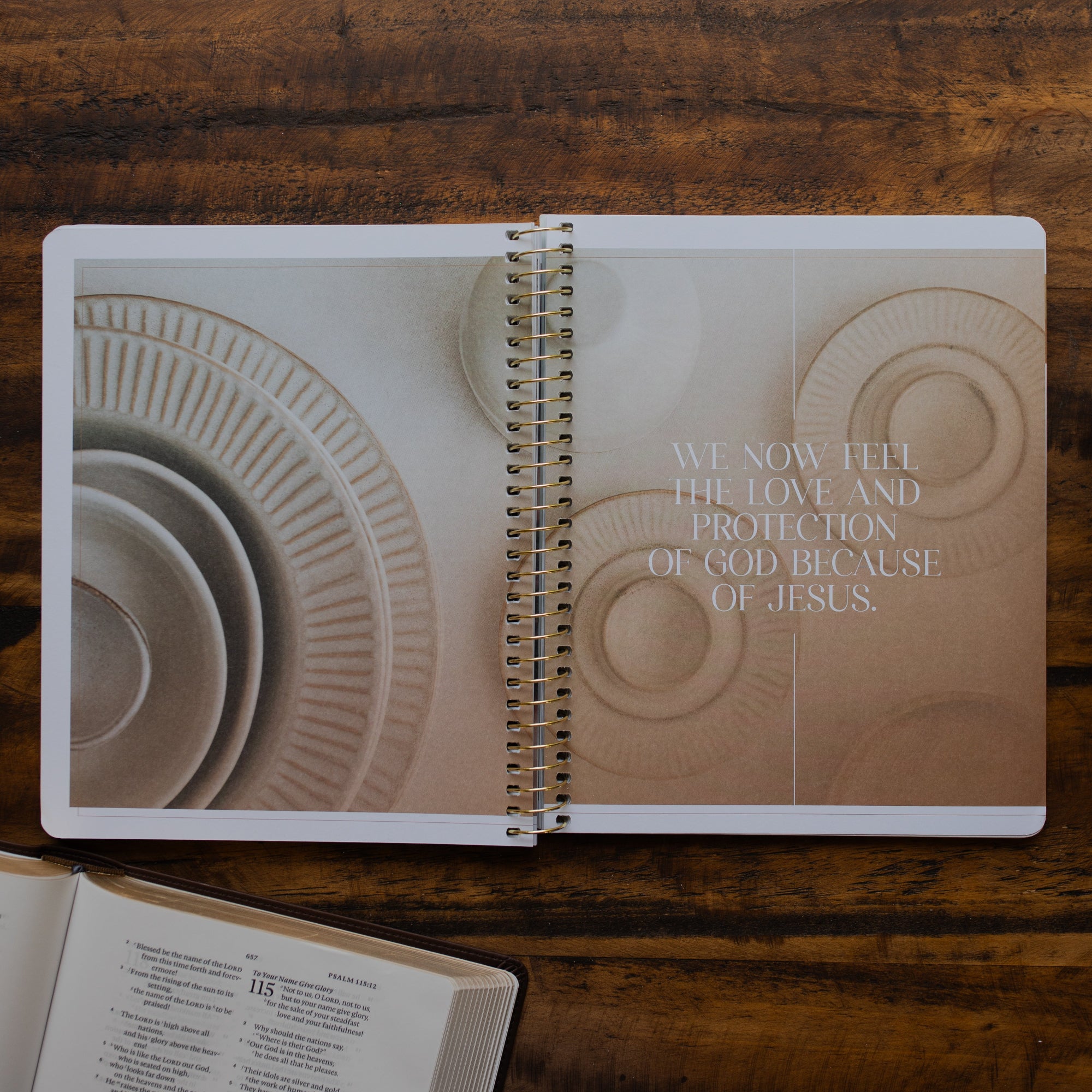 Eden to Eternity Spiral opened to the devotional and picture page on a wooden table next to an open bible