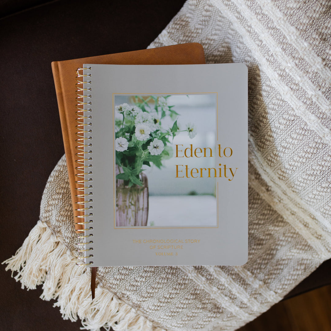 Eden to Eternity Spiral cover on a leather booklet on a textured blanket