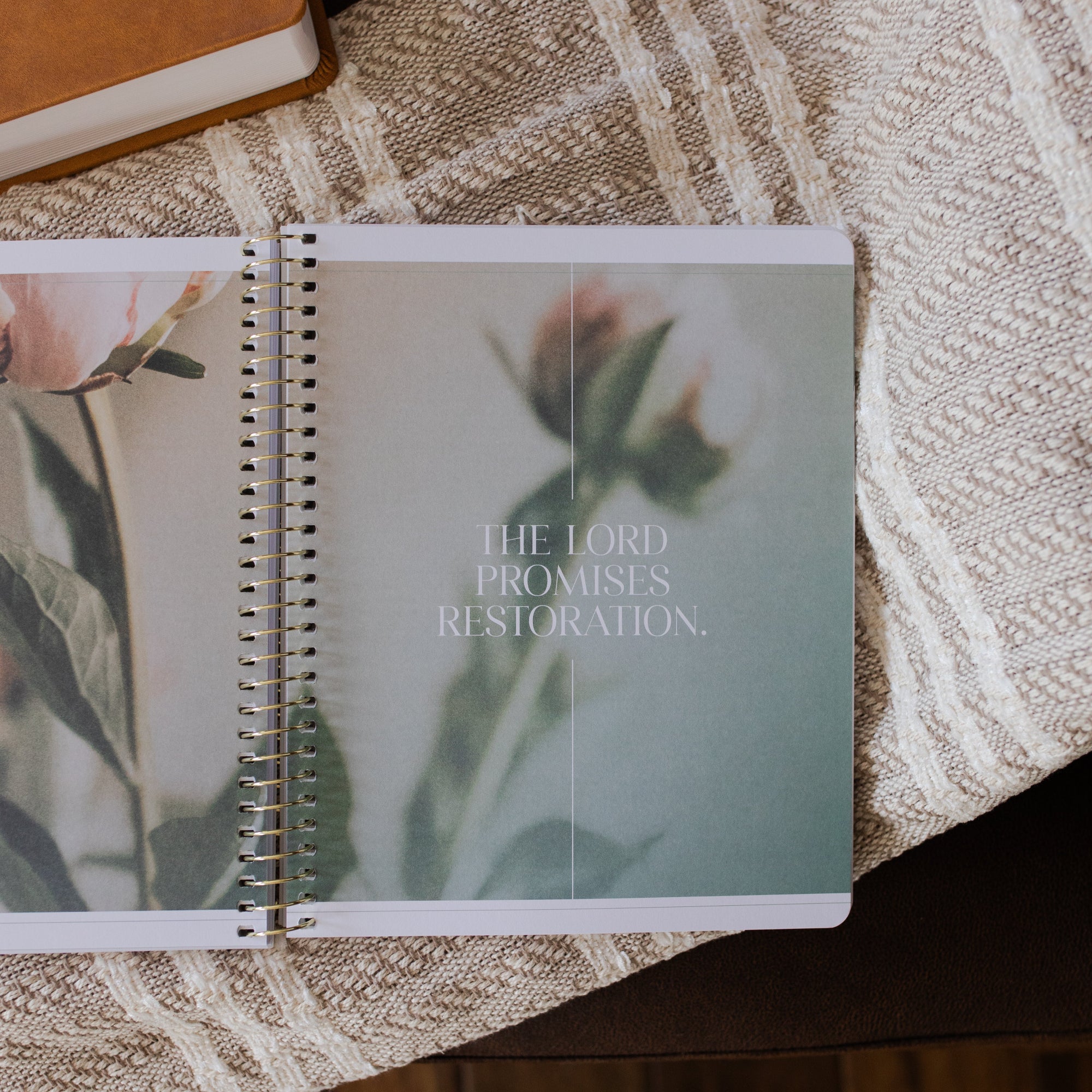 Eden to Eternity Spiral opened to the the lord promises restoration page on a textured blanket