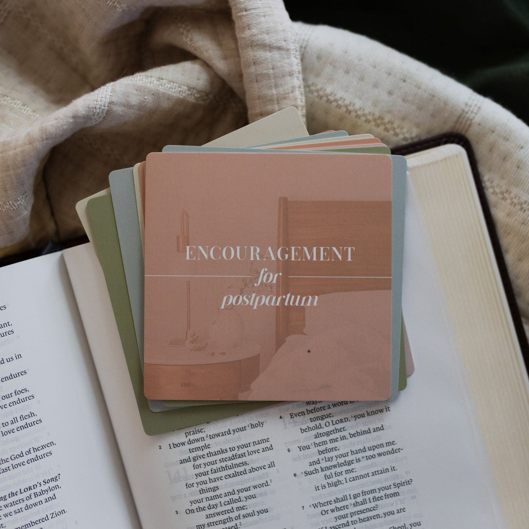 Encouragement for postpartum verse cards laying on a Bible for women