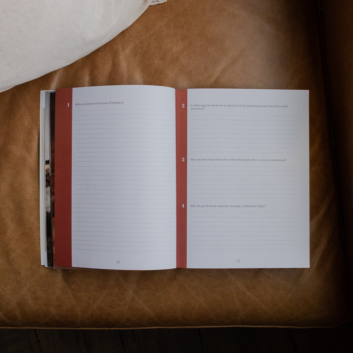Even If Study opened to the Applications and questions page on a leather couch