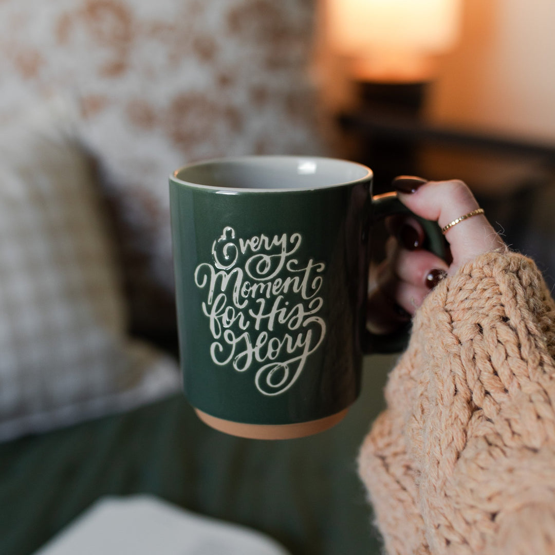 Green Christian mug with white lettering; Lettering spelling Every moment for his glory