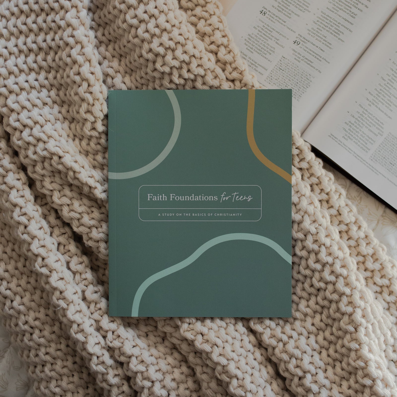 Faith Foundations for Teens study on a knitted blanket on an open bible