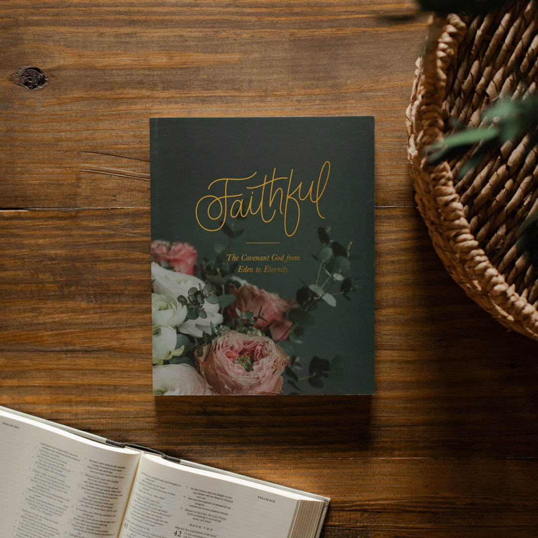 Faithful matte book on a wooden table next to an open bible