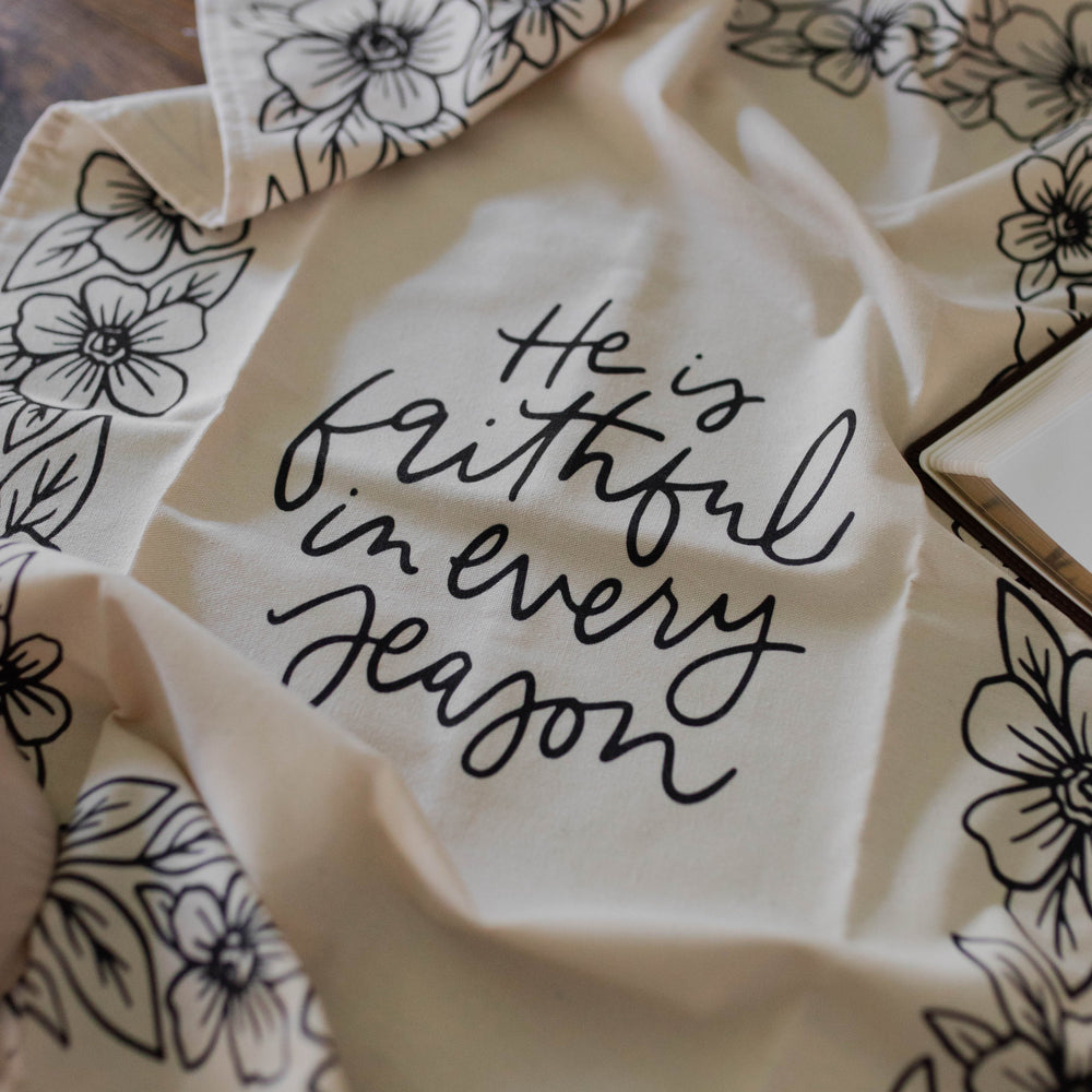 He is Faithful in Every Season Tea Towel open on table