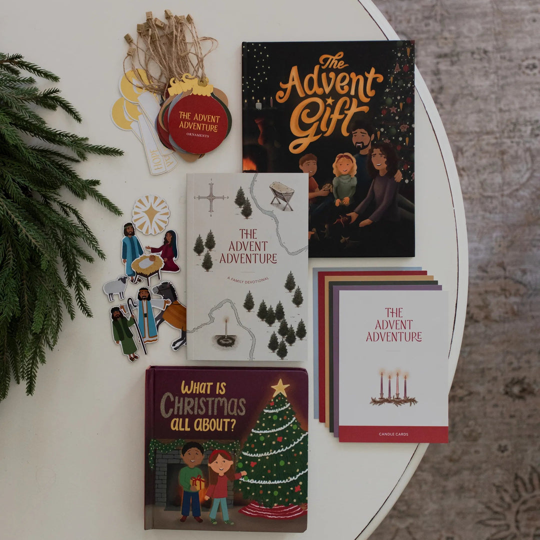 Advent Family bundle laying on a white table near some greenery