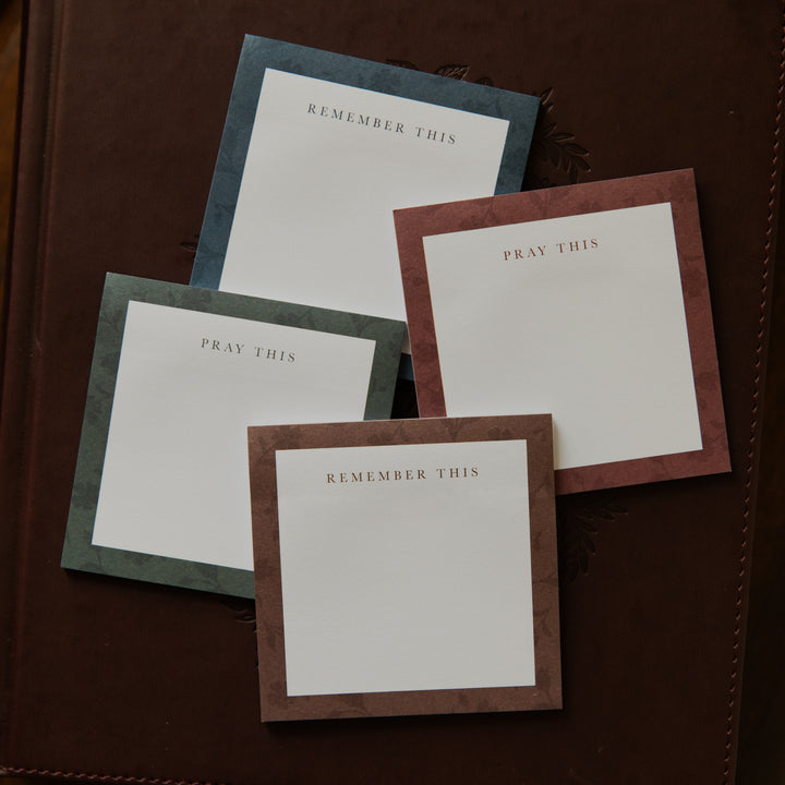 Up close of Four stacks of Floral Border Sticky Notes on a closed bible
