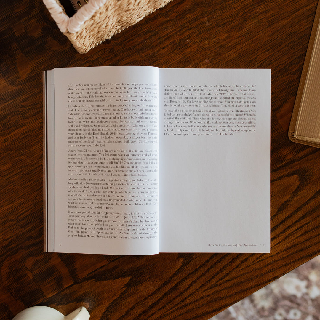 Flourishing in Motherhood Book opened to the end of week 1 page on a wooden table