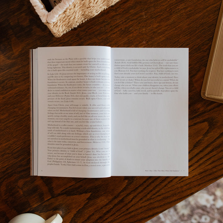 Flourishing in Motherhood Book opened to the end of week 1 page on a wooden table