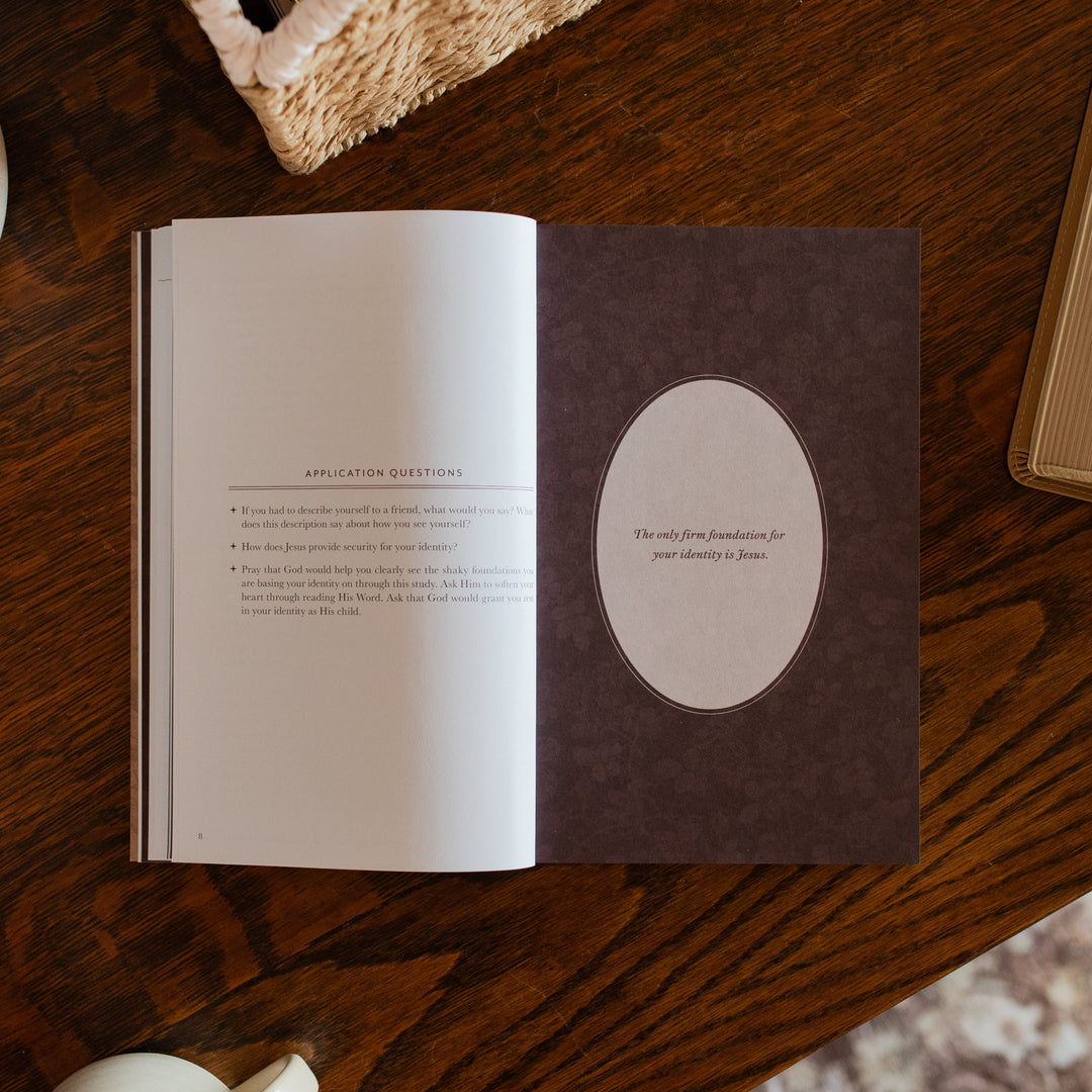 Flourishing in Motherhood Book opened to the applications and questions page on a wooden table