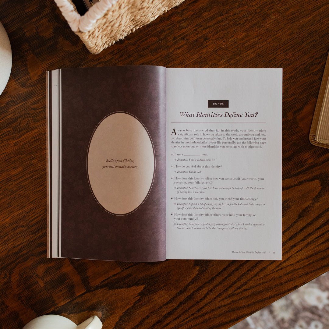 Flourishing in Motherhood Book opened to the bonus page on a wooden table