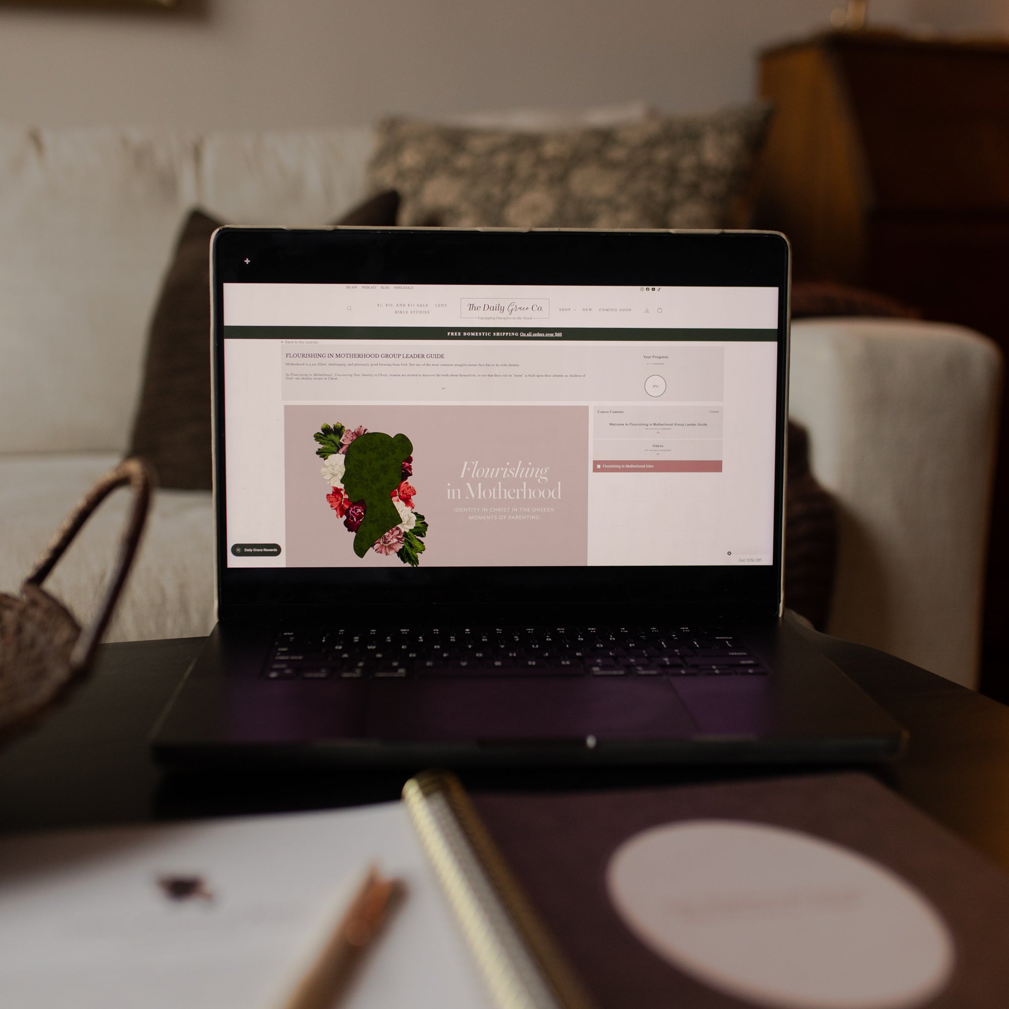 Laptop on a table with a website open to the Flourishing in Motherhood Group Leader Guide
