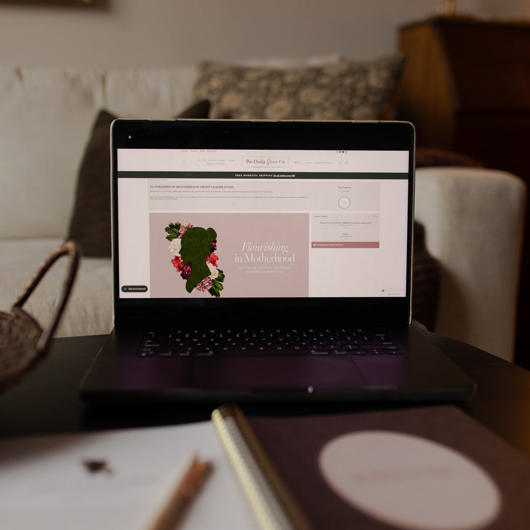 Laptop on a table with a website open to the Flourishing in Motherhood Group Leader Guide
