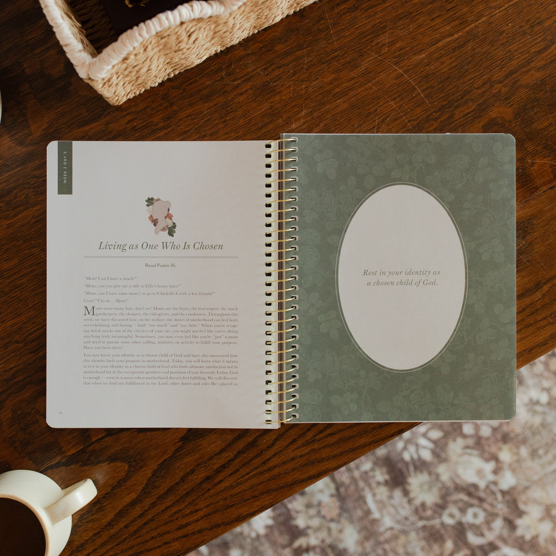 Flourishing in Motherhood spiral study opened to the Living as One who is chosen page on a wooden table near a coffee cup