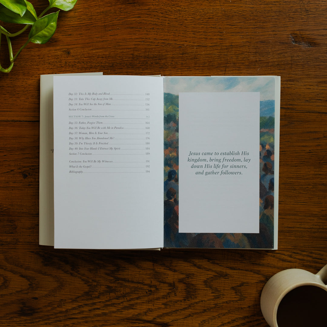 Forty Sayings of Jesus hardcover opened to the end of the Table of Contents page near a coffee cup on a wooden table