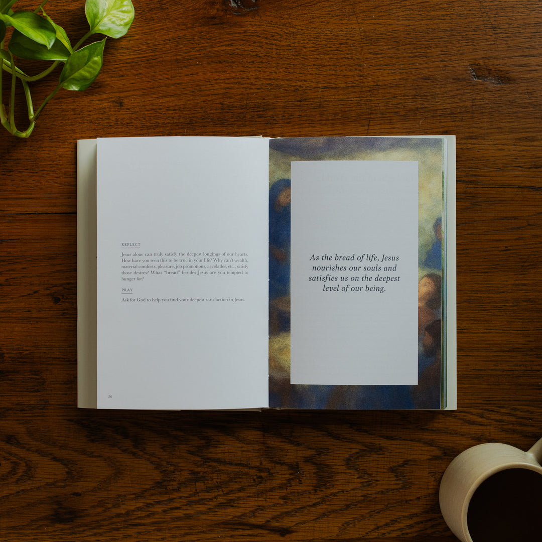 Forty Sayings of Jesus hardcover opened to the reflections and prayer page near a coffee cup on a wooden table