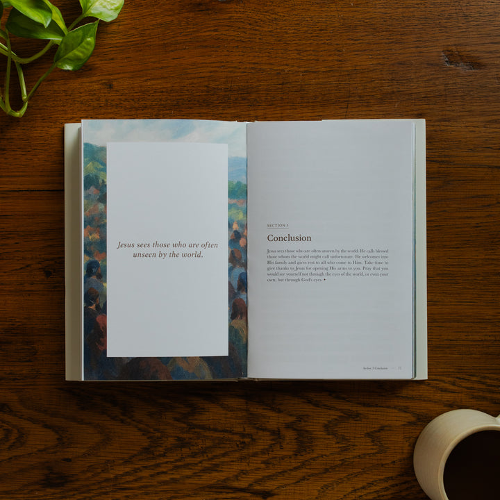 Forty Sayings of Jesus hardcover opened to the conclusions page for section 3 near a coffee cup on a wooden table