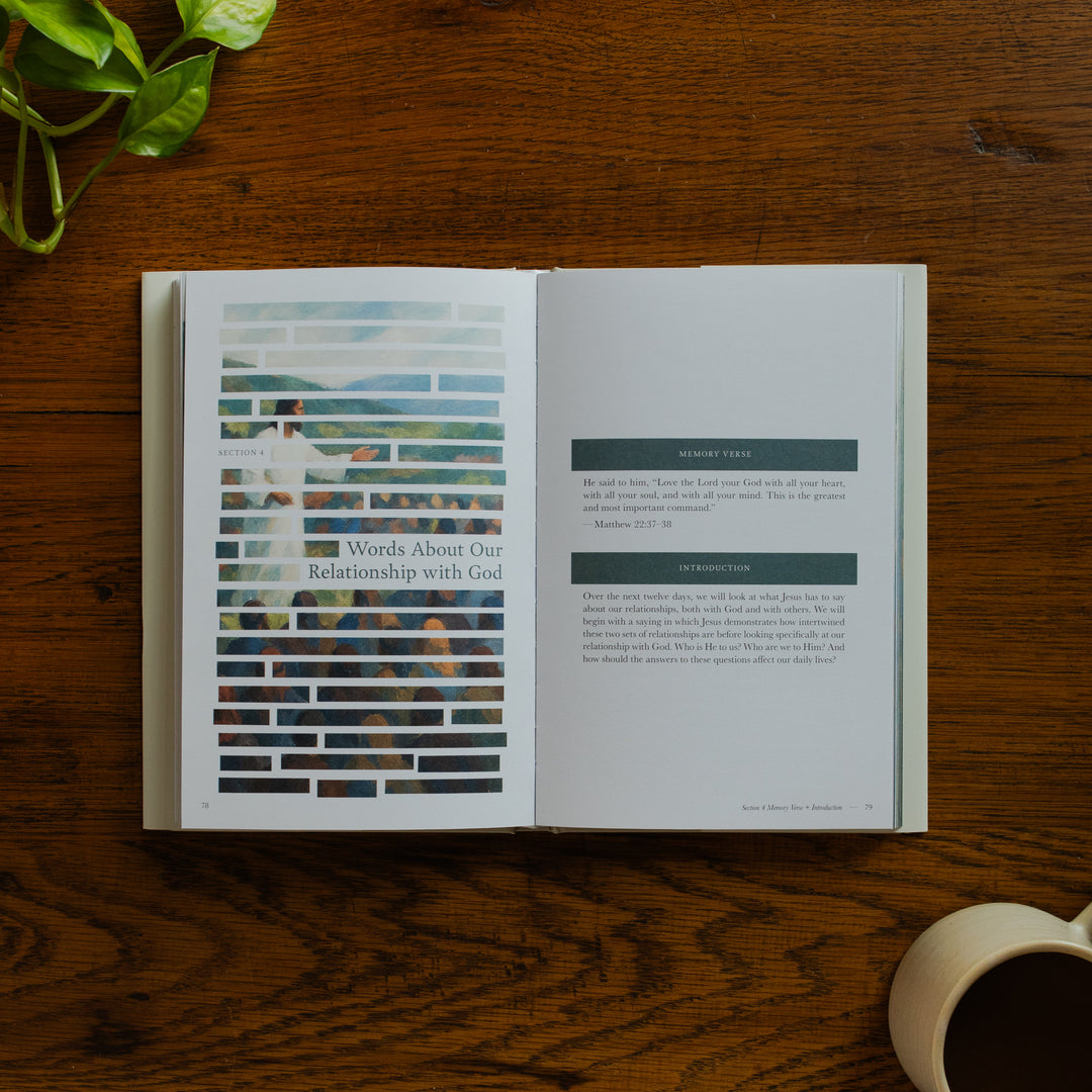 Forty Sayings of Jesus hardcover opened to the Words about Our Relationship with God page near a coffee cup on a wooden table