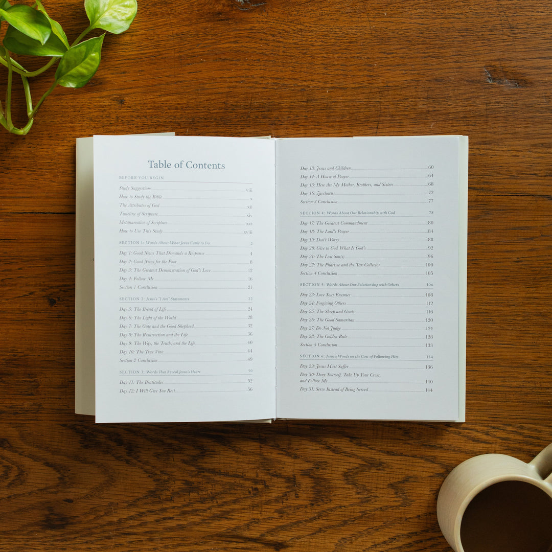 The Forty Sayings of Jesus book on a wooden table opened to the table of contents page