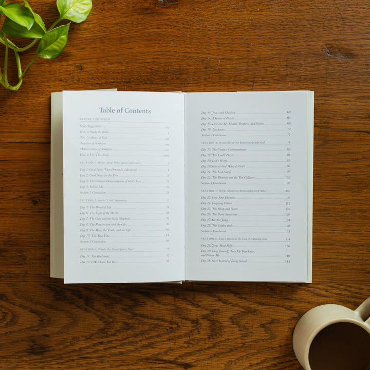 The Forty Sayings of Jesus book on a wooden table opened to the table of contents page