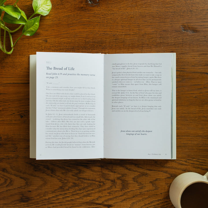 The Forty Sayings of Jesus book on a wooden table opened to the Bread of Life page
