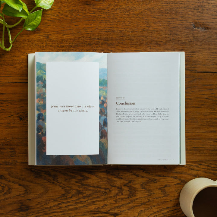 The Forty Sayings of Jesus book on a wooden table opened to the conclusion page