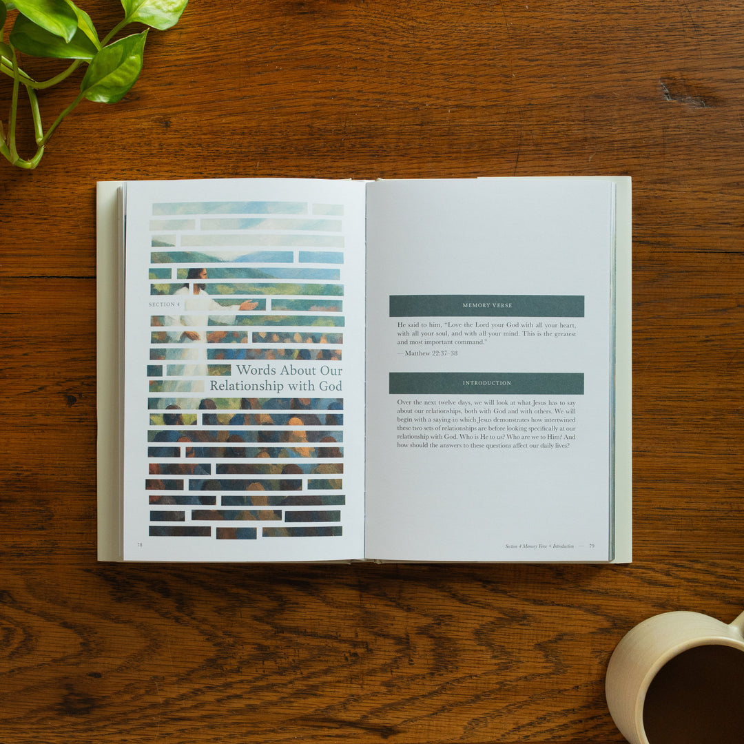 The Forty Sayings of Jesus book on a wooden table opened to the memory verse and introduction page