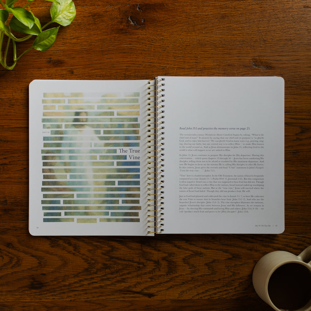 Forty Sayings of Jesus spiral opened to the True Vine page near a coffee cup on a wooden table