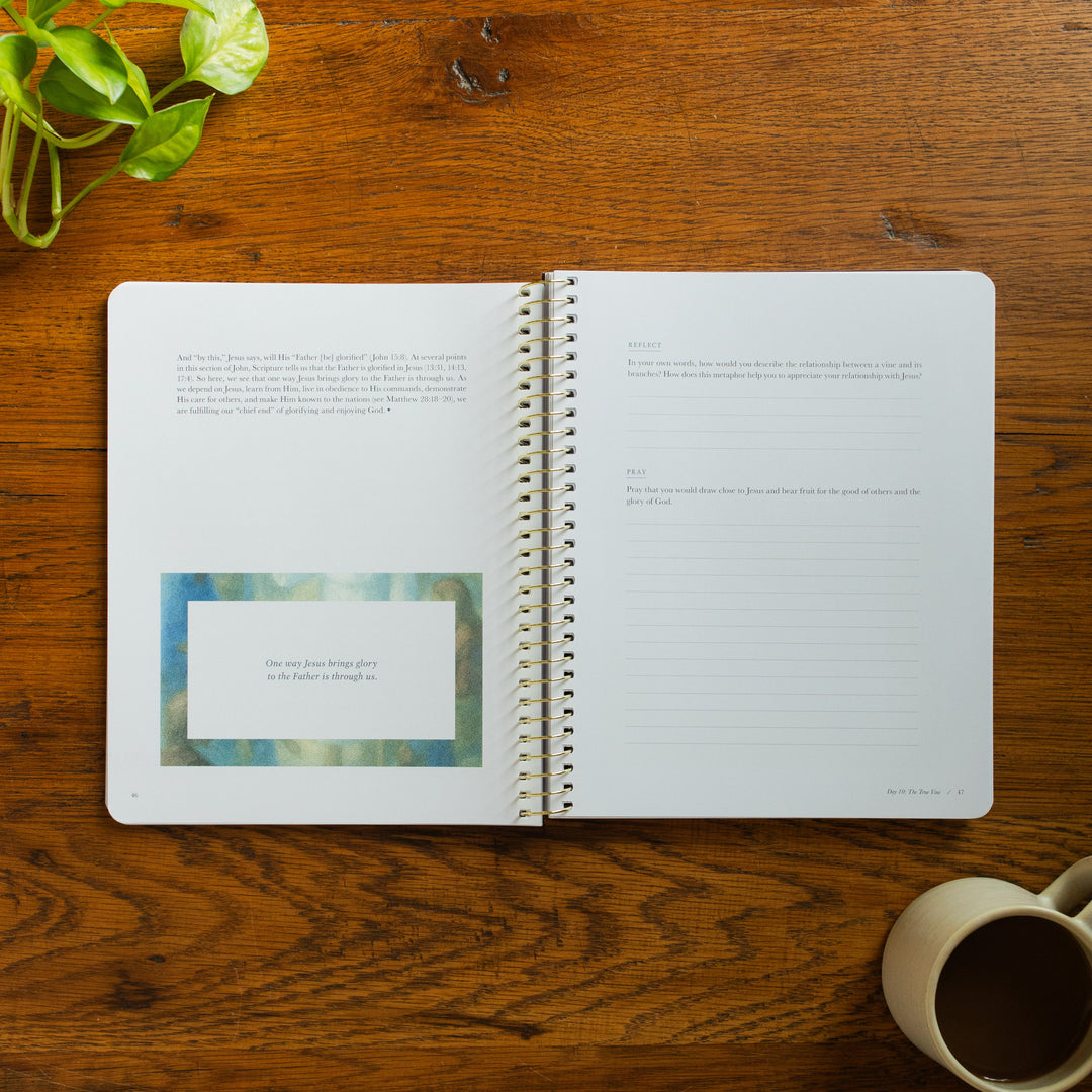 The Forty Sayings of Jesus Spiral opened to the reflections and pray page on a wooden table