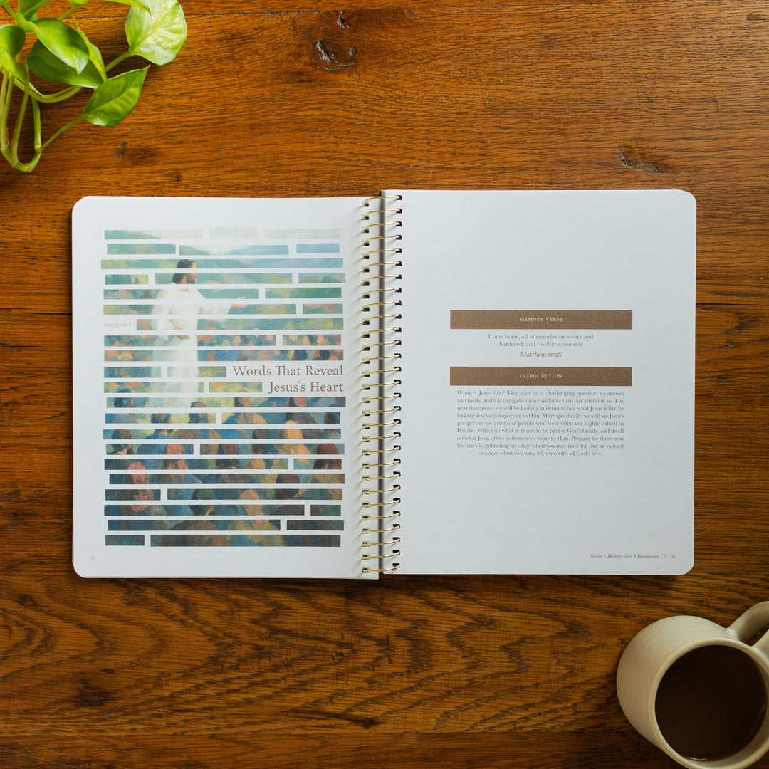 The Forty Sayings of Jesus Spiral opened to the Words that Reveal Jesus's Heart  page on a wooden table