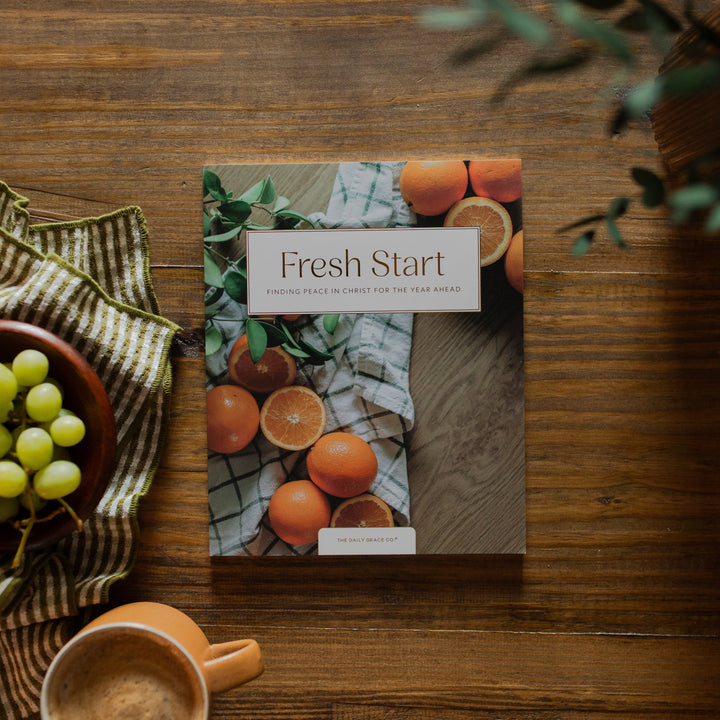 Fresh Start Bible study cover on a wooden table next to a bowl of grapes and a coffee cup
