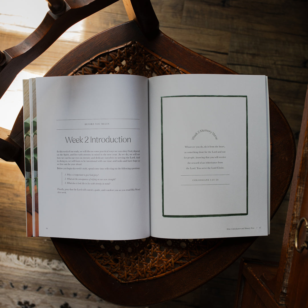 Fresh Start Bible study opened to the Week 2 introduction page on a woven chair