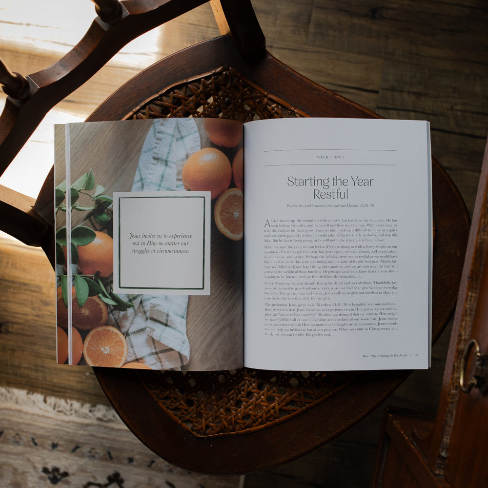 Fresh Start Bible study opened to the Starling the Year Restful page on a woven chair